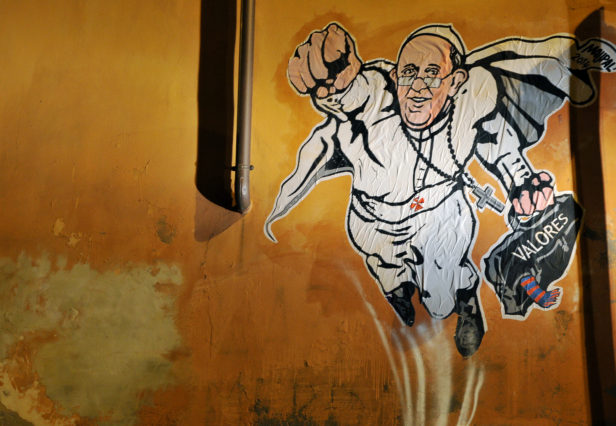 A view of a street art mural by Italian street artist Maupal which depicts Pope Francis as a superman, flying through the air with his white papal cloak billowing out behind him and holding a bag bearing the word "Values", in downtown Rome near the Vatican on January 28, 2014. The image, created by Italian street artist Maupal, was tweeted today by the Vatican communication twitter account ( @PCCS_VA ). Flying forward with his fist raised, the heroic pontiff -- crucifix swinging in the wind -- carries his trademark black bag, with the word "values" written across it in white. AFP PHOTO / TIZIANA FABI